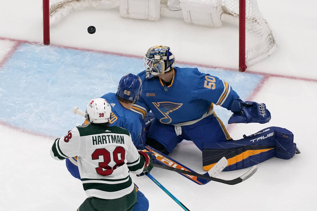 Minnesota Wild's Ryan Hartman (38) scores past St. Louis Blues goaltender Jordan Binnington (50) an...