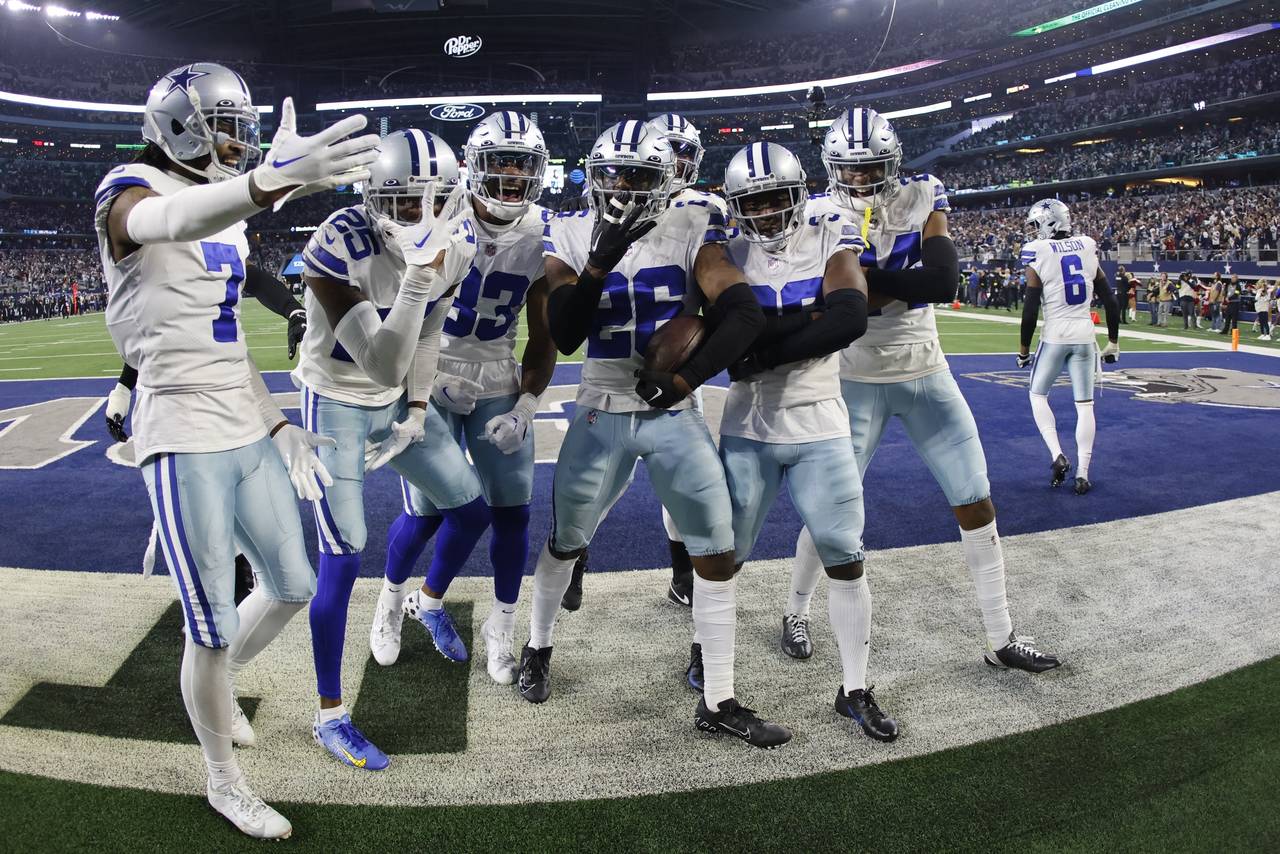 Dallas Cowboys' DaRon Bland celebrates his interception with teammates during the second half of an...