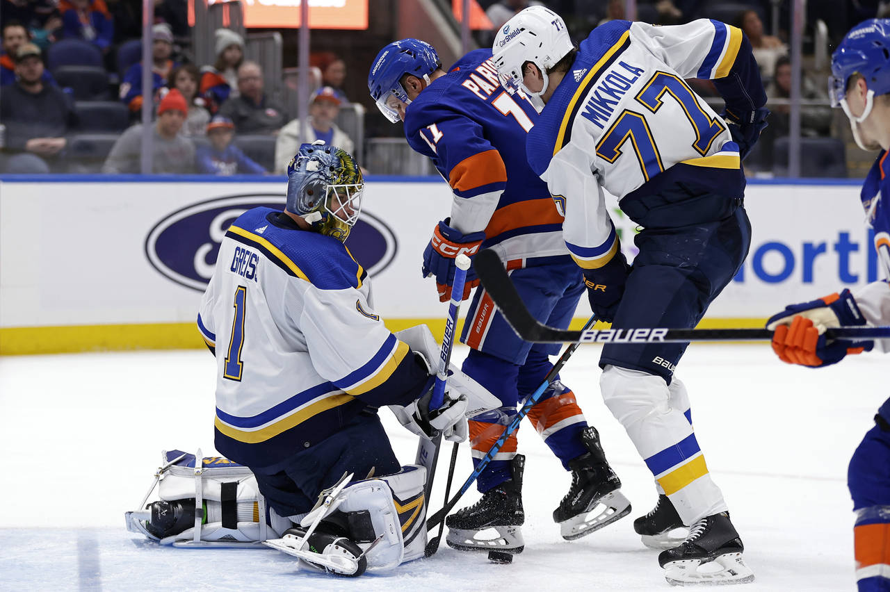St. Louis Blues goaltender Thomas Greiss makes a save against New York Islanders left wing Zach Par...