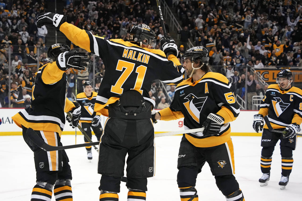 Pittsburgh Penguins' Evgeni Malkin (71) celebrates his goal against the New York Rangers during the...