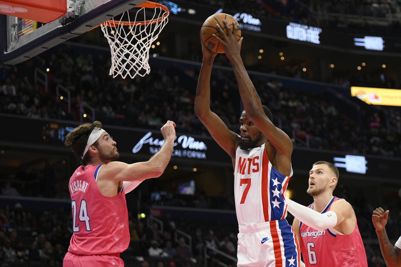 Brooklyn Nets forward Kevin Durant (7) grabs the rebound against Washington Wizards forward Corey K...