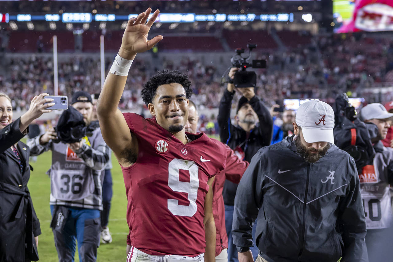 Alabama quarterback Bryce Young (9) salutes the fans as he leaves the field following an NCAA colle...