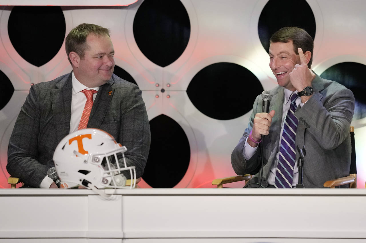 Clemson head coach Dabo Swinney, right, and Tennessee head coach Josh Heupel, answer questions from...