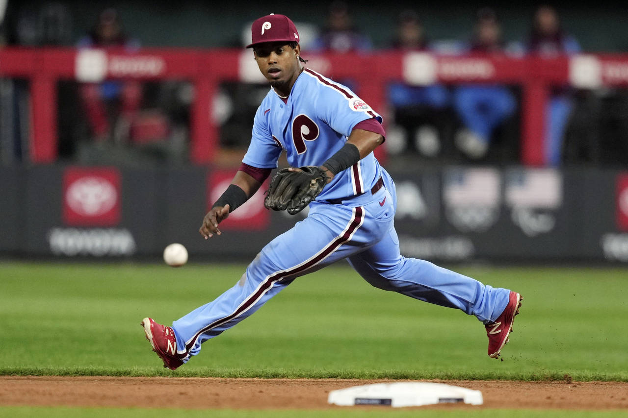 FILE - Philadelphia Phillies second baseman Jean Segura fields a single hit by Houston Astros' Jose...