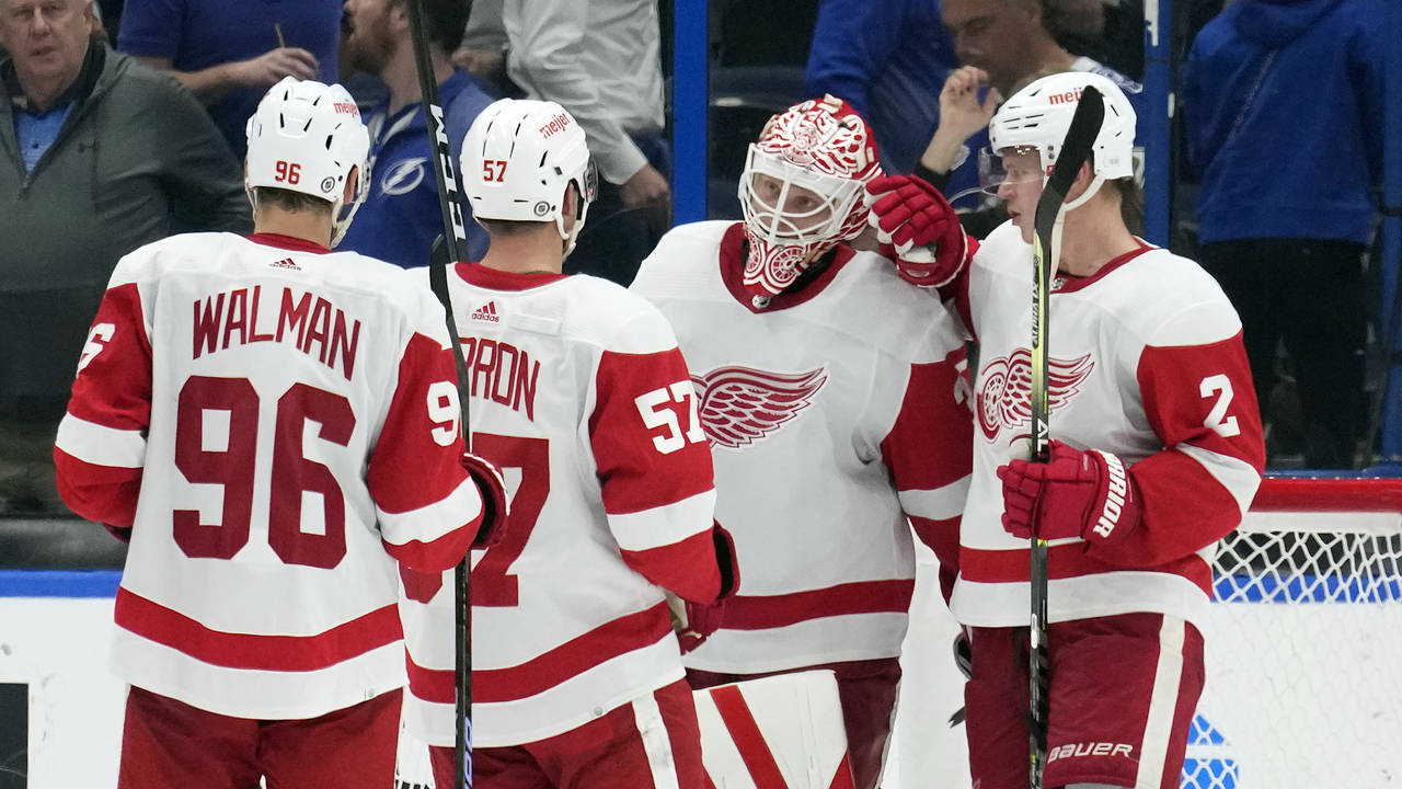 Detroit Red Wings goaltender Ville Husso (35) celebrates with teammates, including defenseman Olli ...