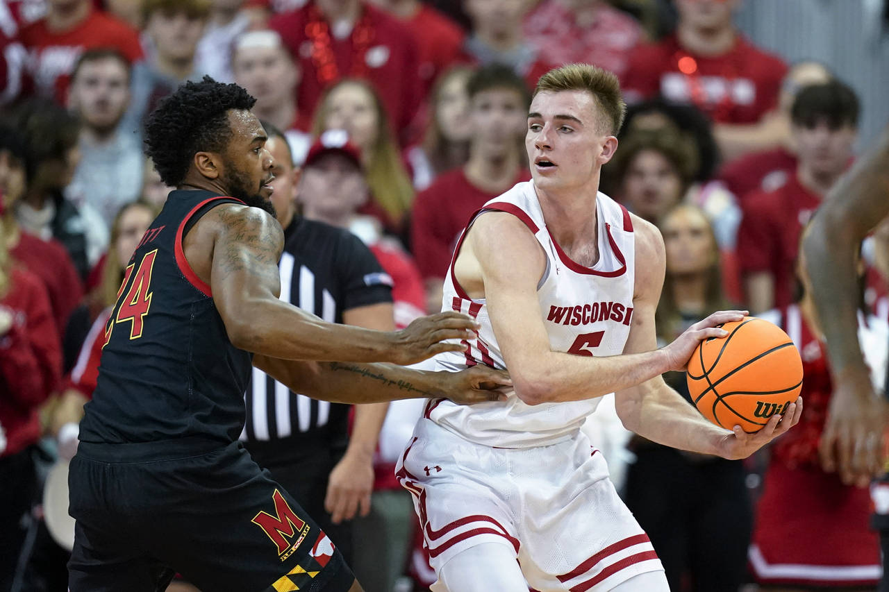 Wisconsin's Tyler Wahl (5) looks to pass the ball as Maryland's Donta Scott (24) defends during the...