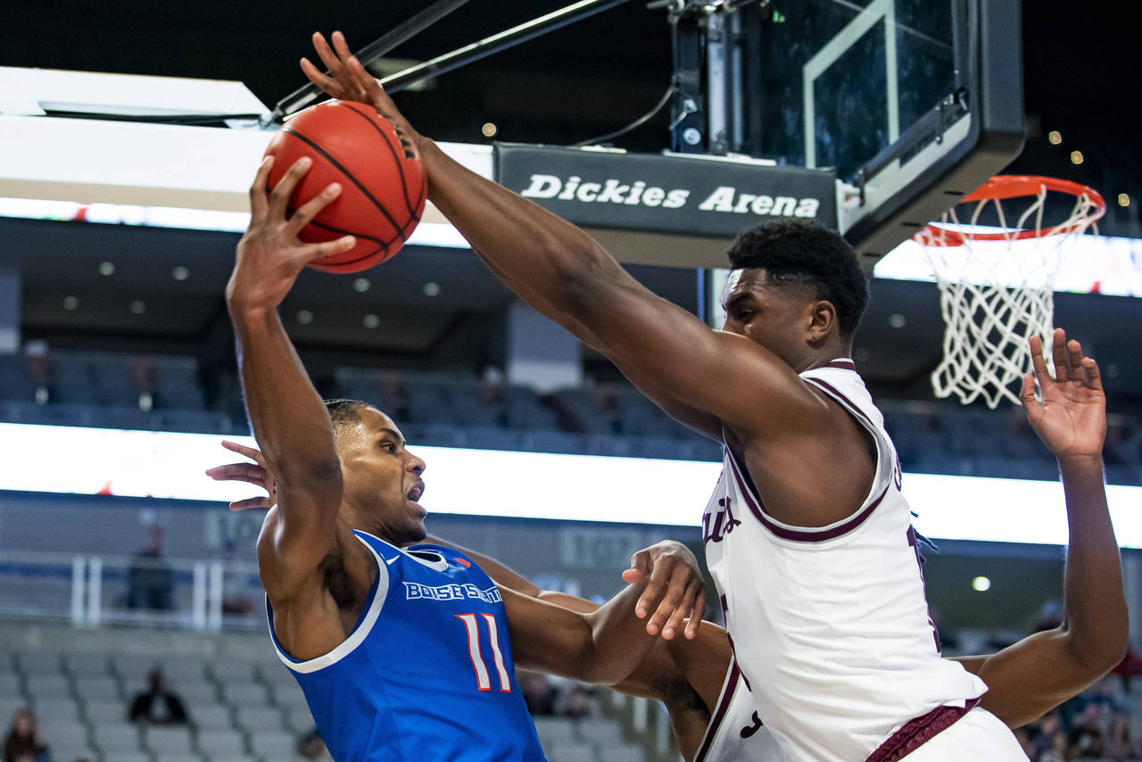 Boise State guard Chibuzo Agbo (11) attempts to pass the ball to a teammate as Texas A&M forward Ju...