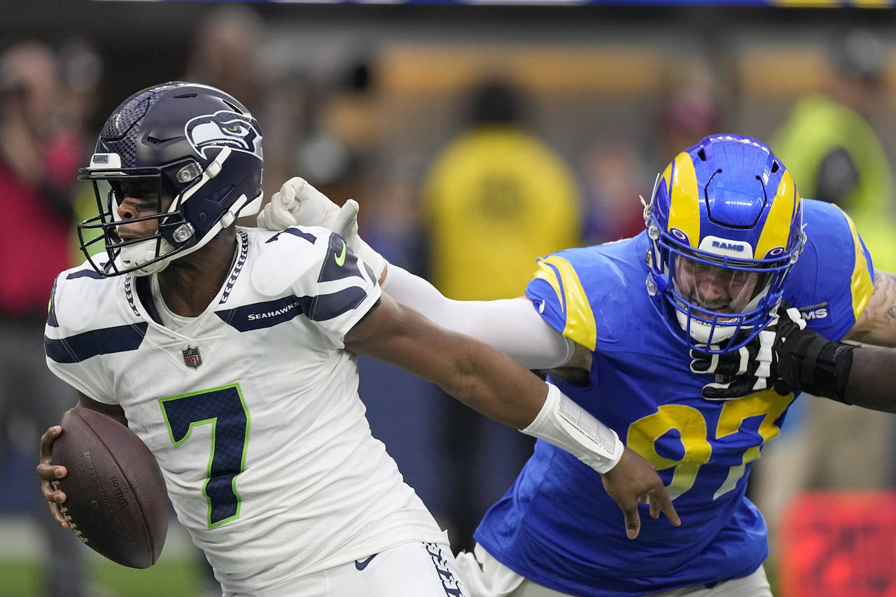 Los Angeles Rams defensive tackle Michael Hoecht (97) sacks Seattle Seahawks quarterback Geno Smith...