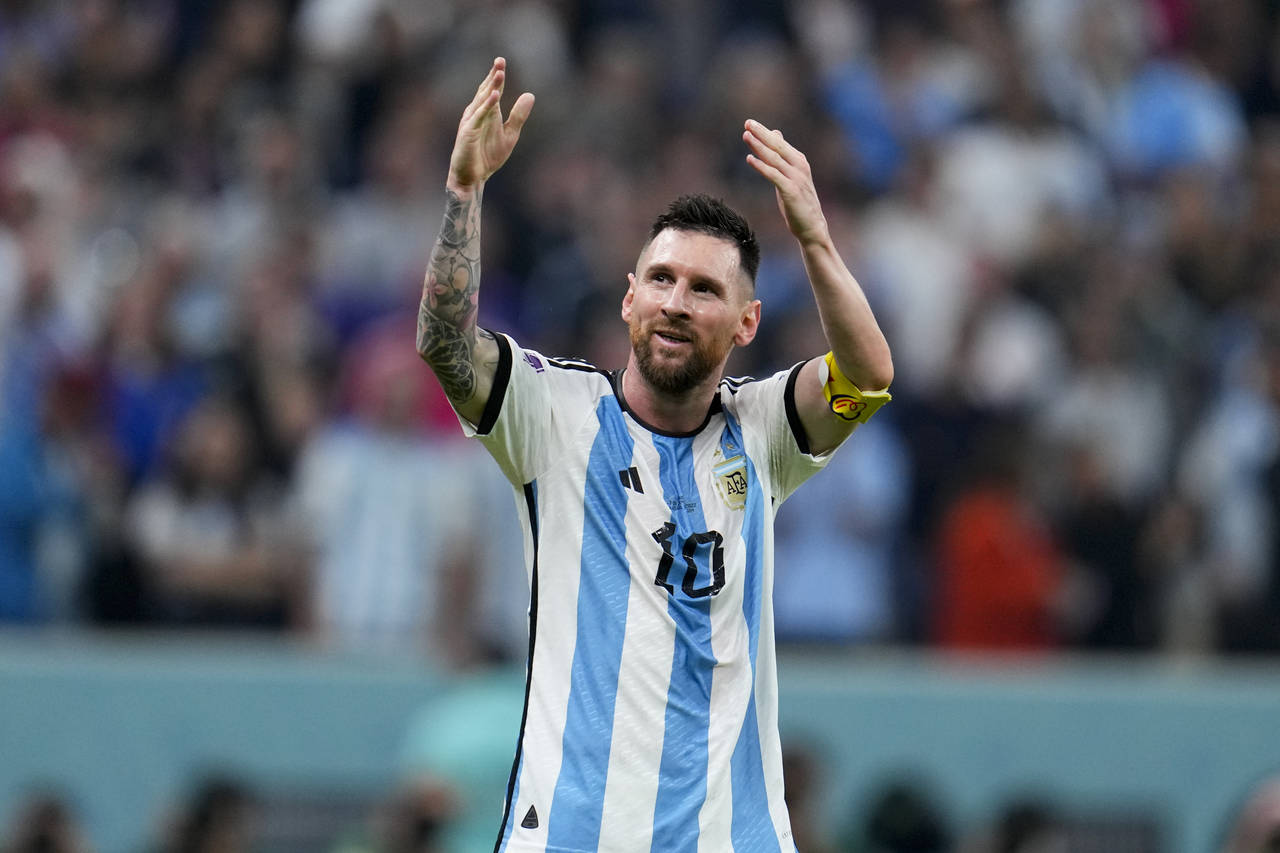 Argentina's Lionel Messi celebrates after his teammate Julian Alvarez scored his side's third goal ...