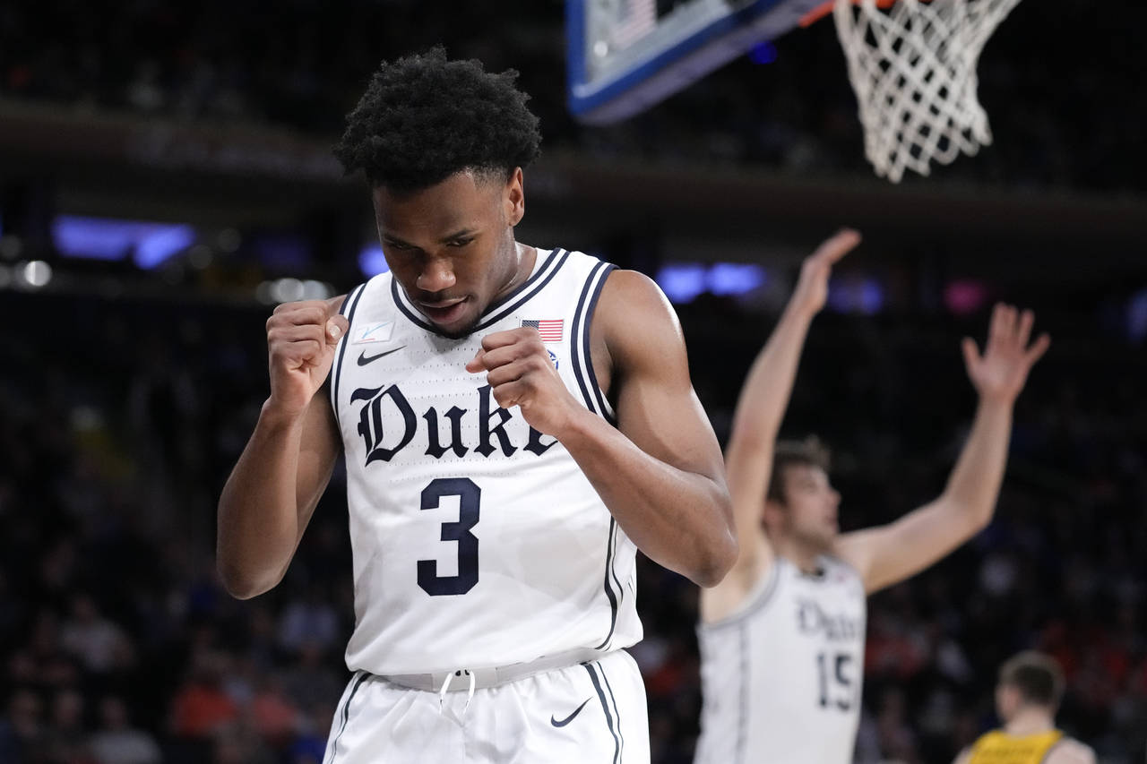 Duke's Jeremy Roach (3) reacts after scoring and drawing a foul during the first half of the team's...