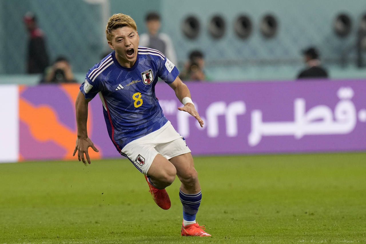 Japan's Ritsu Doan celebrates scoring his side's first goal during a World Cup group E soccer match...