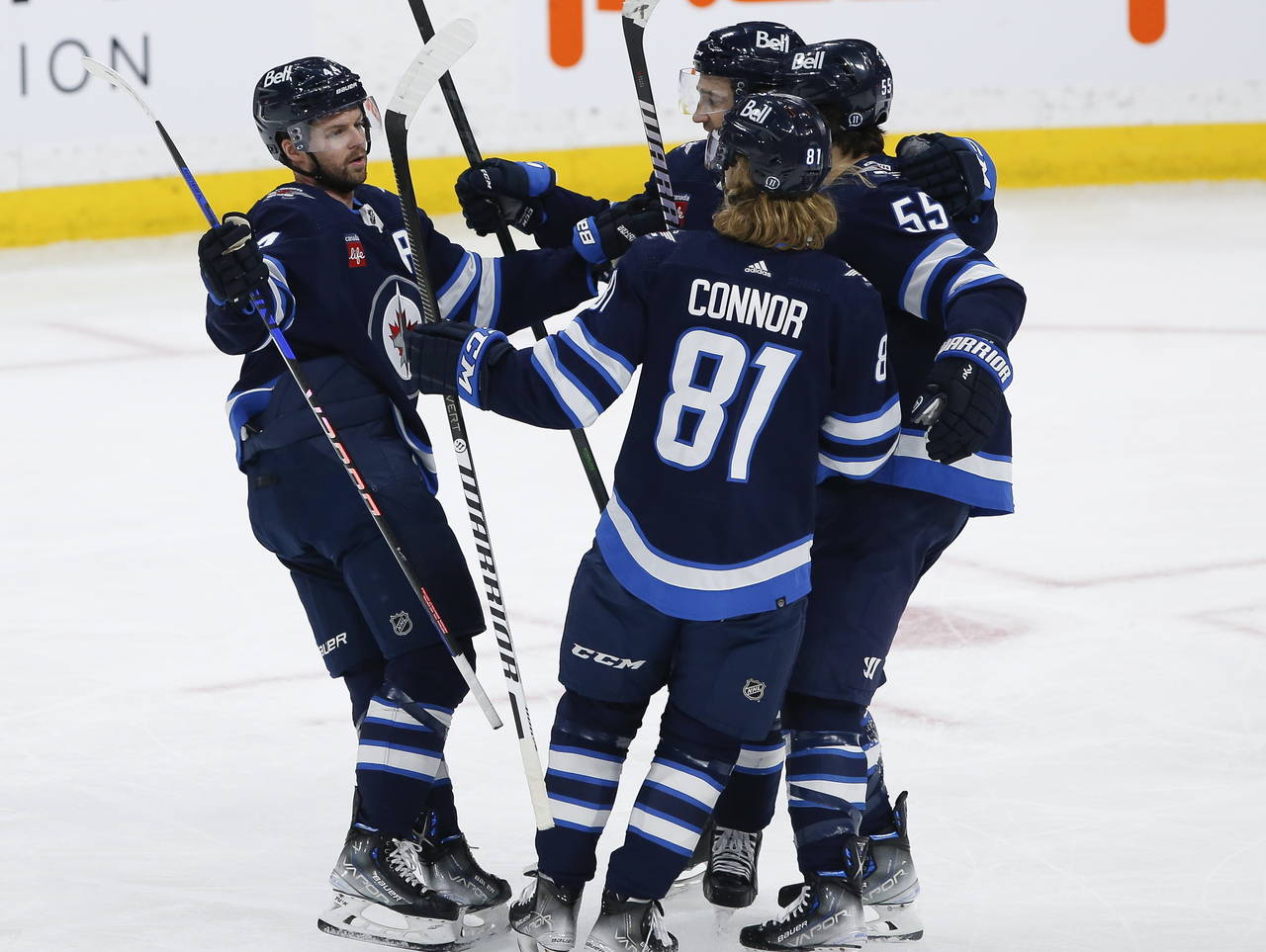 Winnipeg Jets' Josh Morrissey (44), Neal Pionk (4), Kyle Connor (81) and Mark Scheifele (55) celebr...