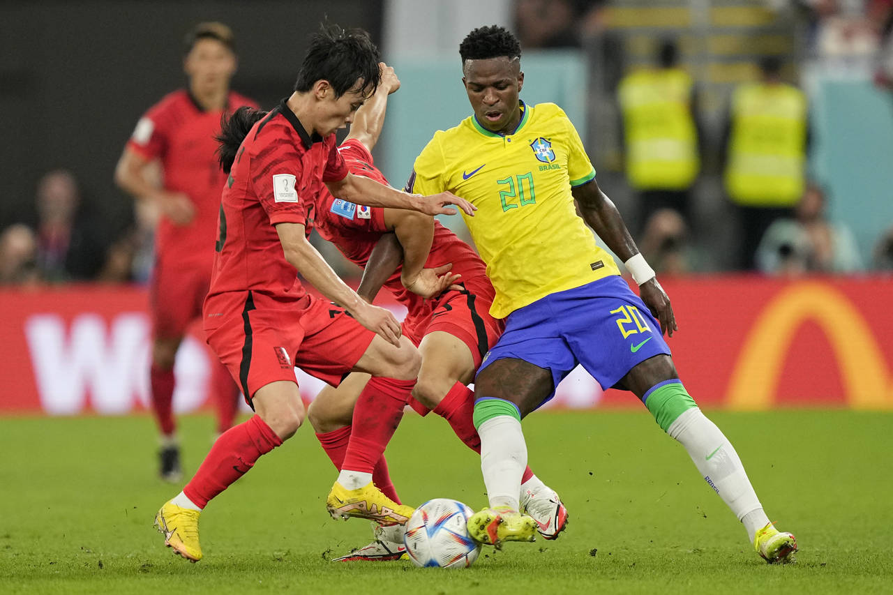 Brazil's Vinicius Junior, right, fights for the ball with South Korea's Kim Moon-hwan, left, and Pa...