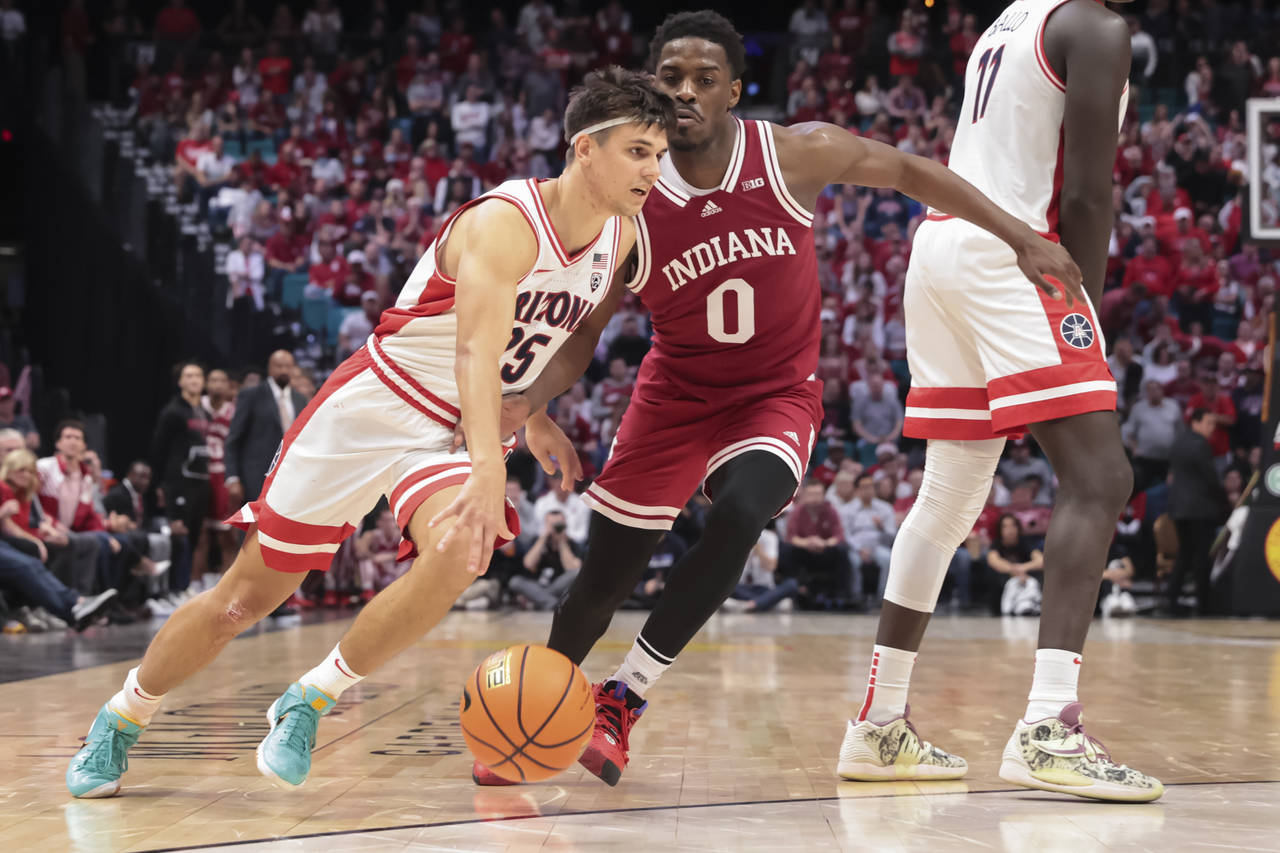 Arizona guard Kerr Kriisa (25) drives against Indiana guard Xavier Johnson (0) during the second ha...