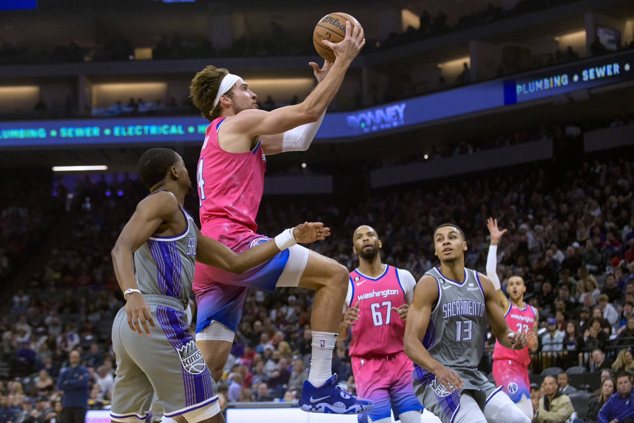 Washington Wizards forward Corey Kispert, second from left, drives to the basket past Sacramento Ki...