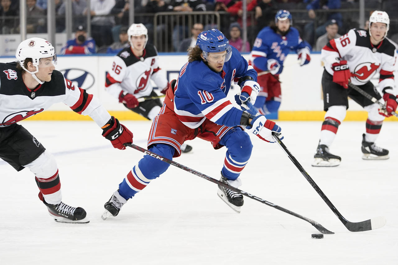 New York Rangers left wing Artemi Panarin (10) skates against New Jersey Devils center Dawson Merce...