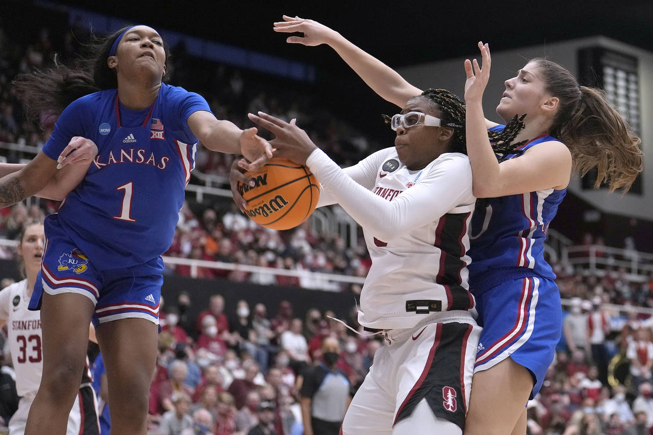 FILE - Stanford forward Francesca Belibi, center, battles for a rebound against Kansas center Taiya...