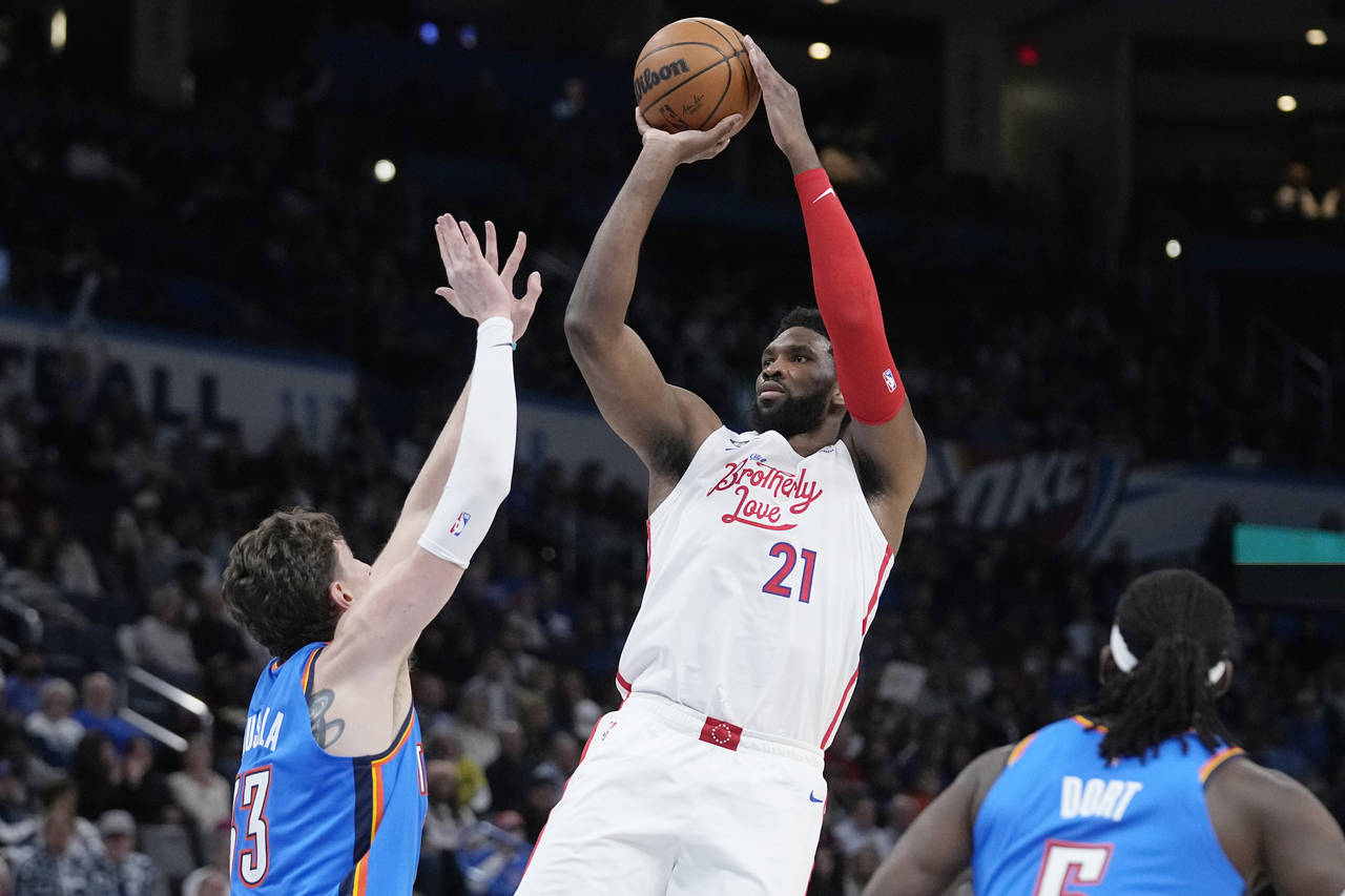 Philadelphia 76ers center Joel Embiid (21) shoots between Oklahoma City Thunder center Mike Muscala...