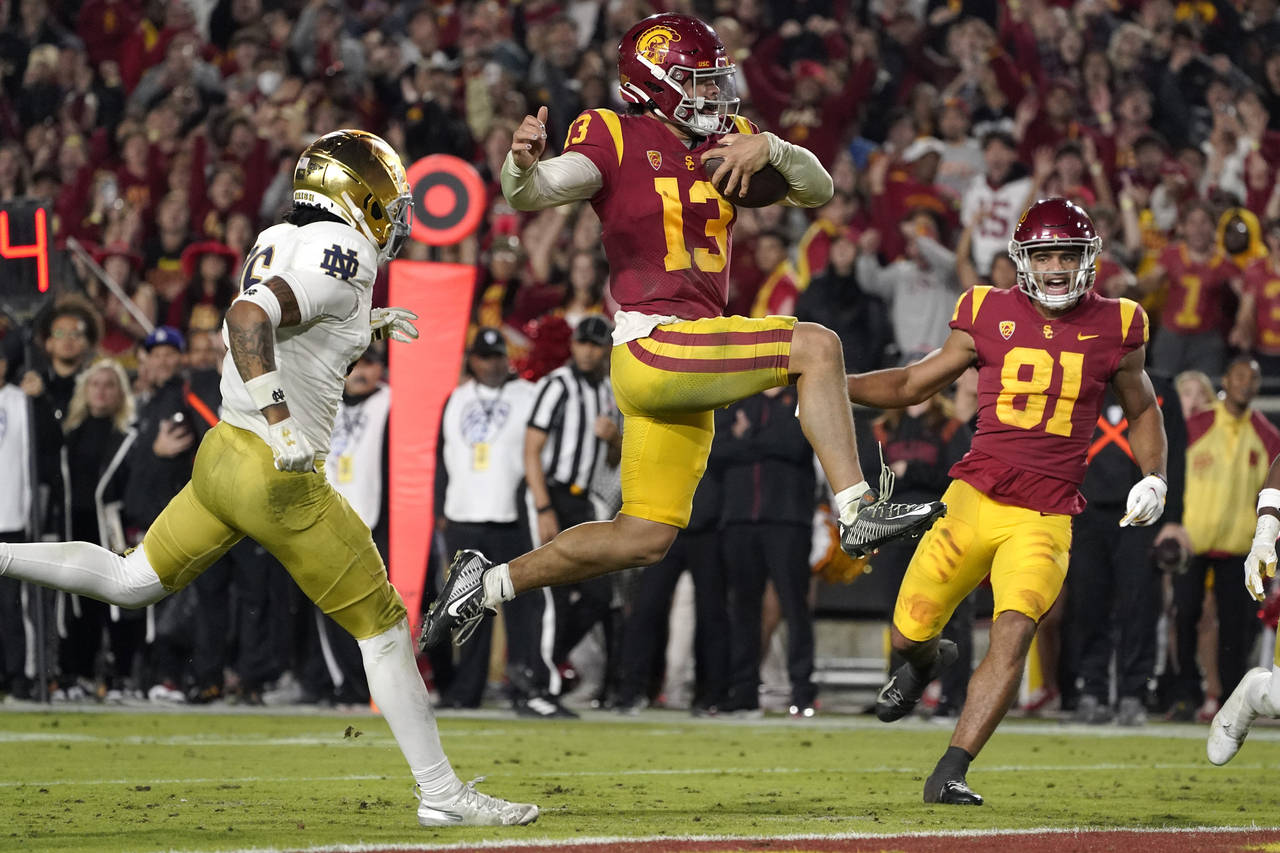 FILE - Southern California quarterback Caleb Williams jumps in for a touchdown as Notre Dame safety...