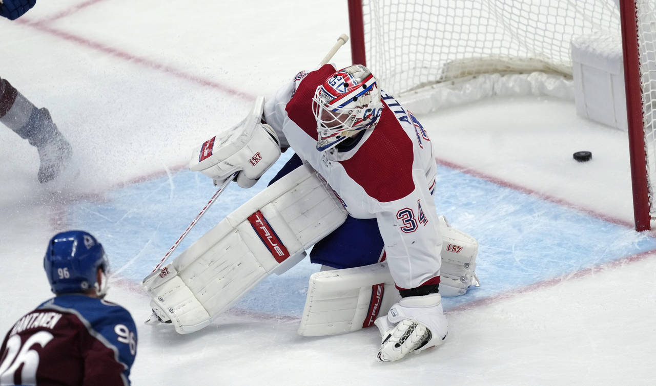 Colorado Avalanche right wing Mikko Rantanen, left, looks on his shot goes in for a score past Mont...