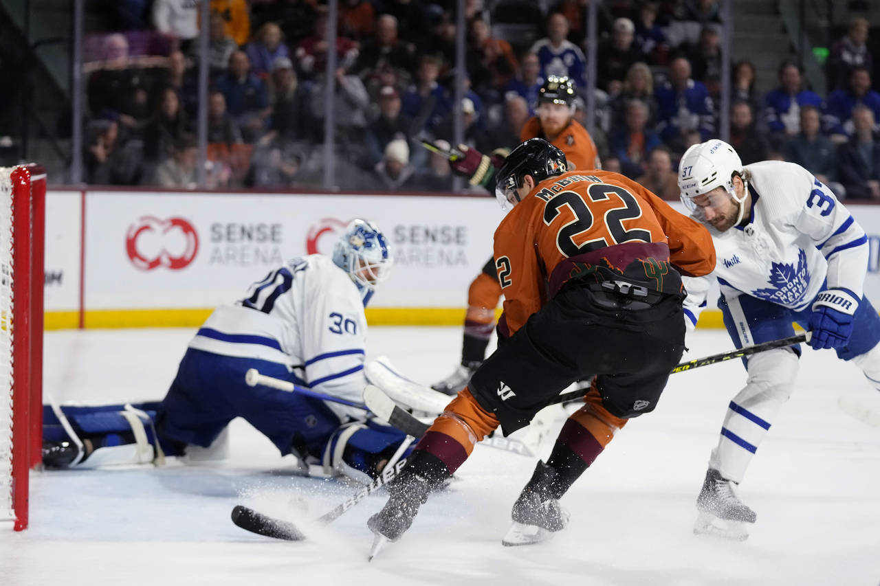 Arizona Coyotes center Jack McBain (22) beats Toronto Maple Leafs goaltender Matt Murray (30) and d...