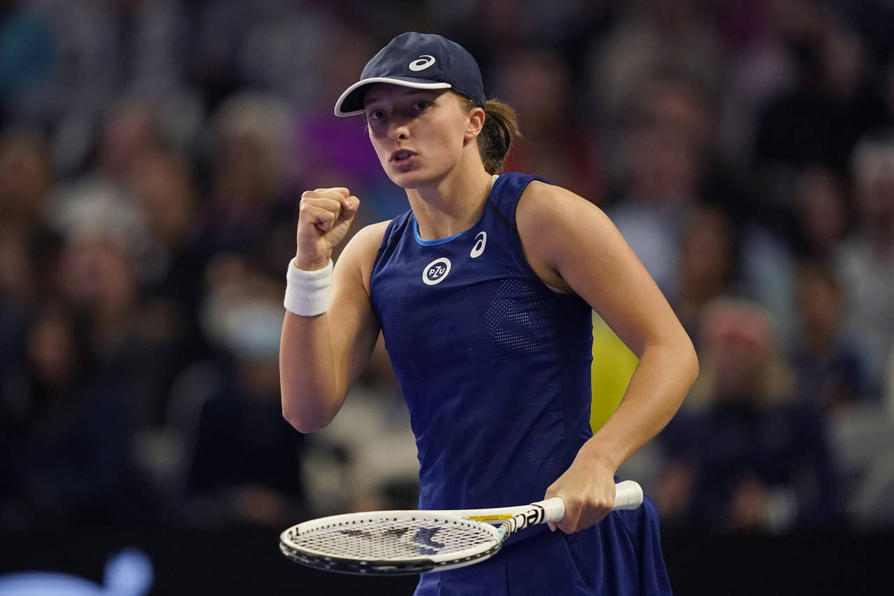 FILE - Iga Swiatek of Poland reacts to scoring a point during the first set against Coco Gauff of t...
