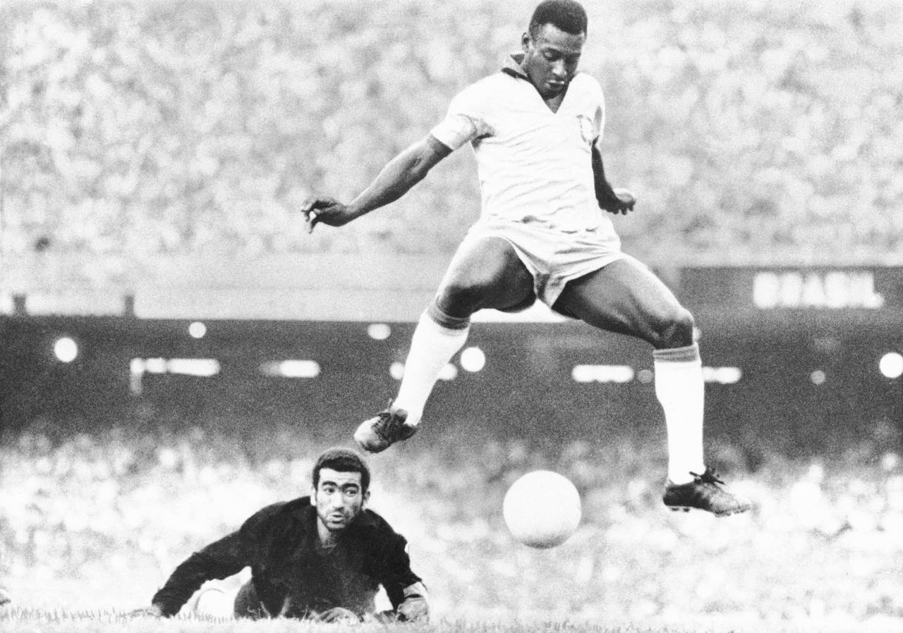 FILE - Brazil's Pele scores past Venezuela's goal keeper Fabrizio Fasano in Rio de Janeiro, Brazil,...