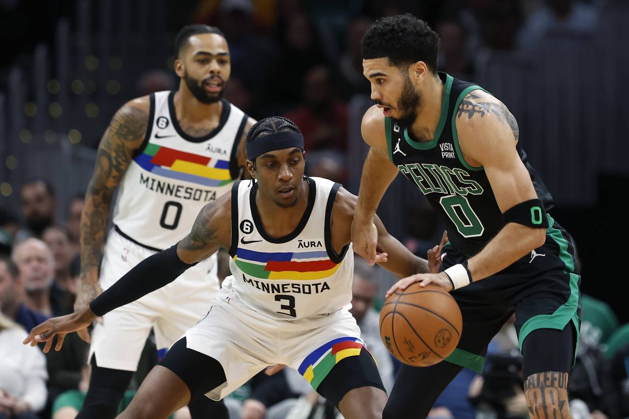 Minnesota Timberwolves' Jaden McDaniels (3) defends against Boston Celtics' Jayson Tatum, right, du...