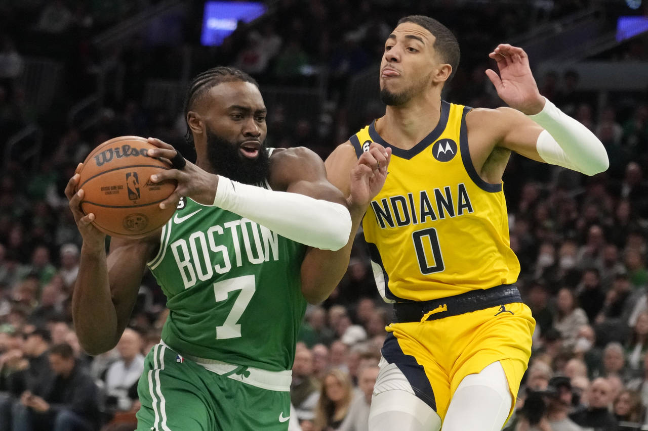 Boston Celtics guard Jaylen Brown (7) drives to the basket against Indiana Pacers guard Tyrese Hali...