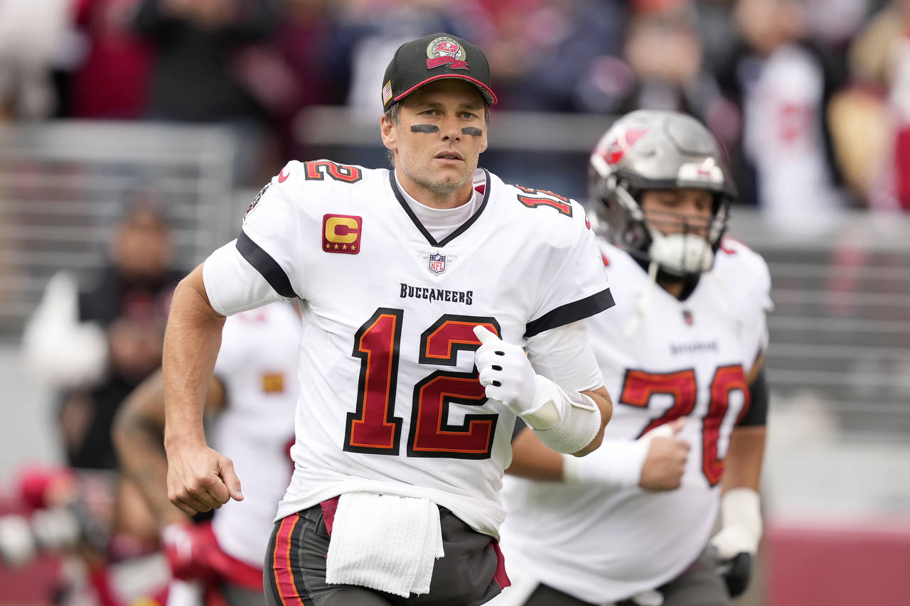 FILE - Tampa Bay Buccaneers quarterback Tom Brady (12) runs on the field before an NFL football gam...