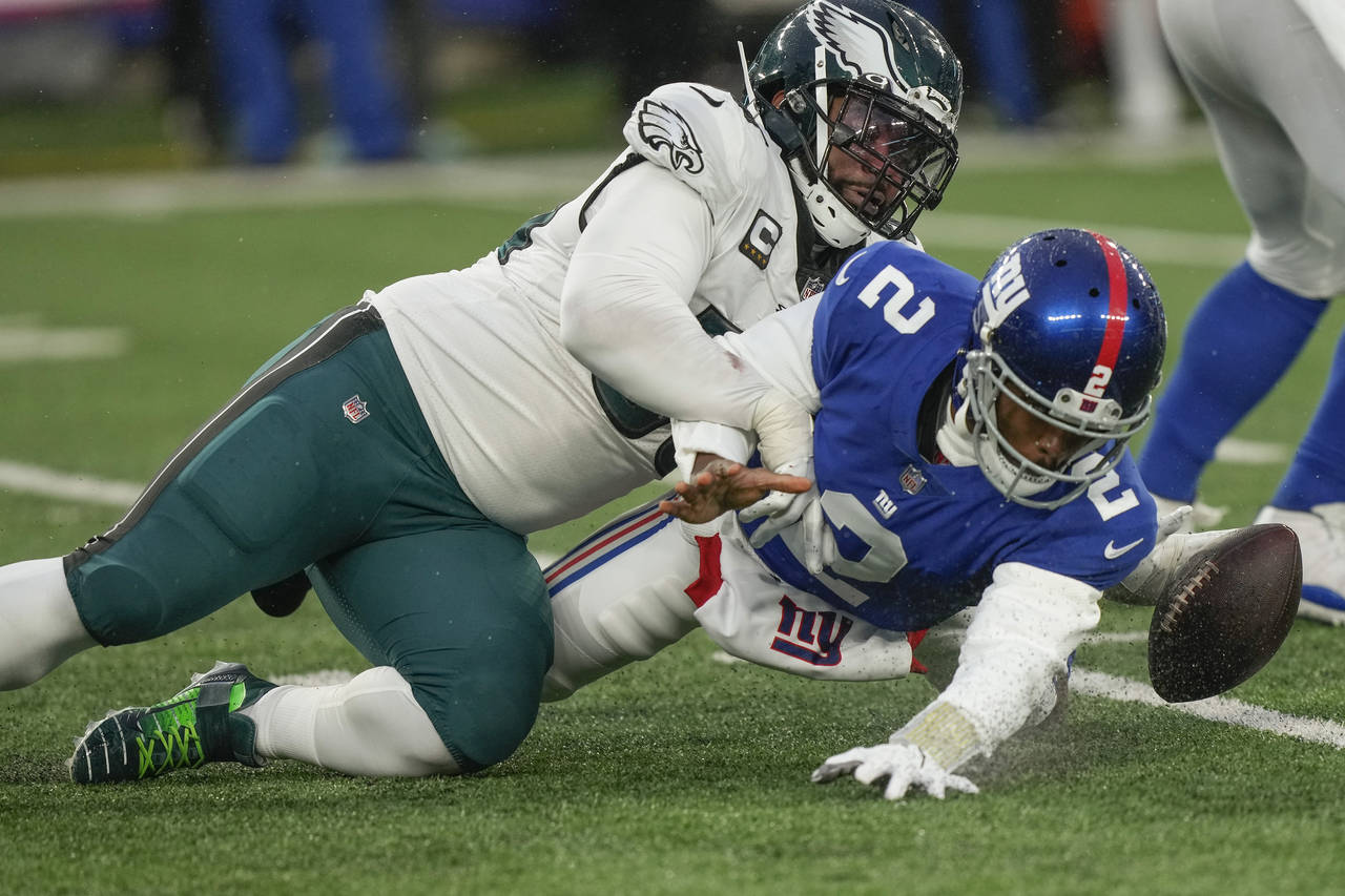 Philadelphia Eagles defensive end Brandon Graham (55) forces a fumble by New York Giants quarterbac...