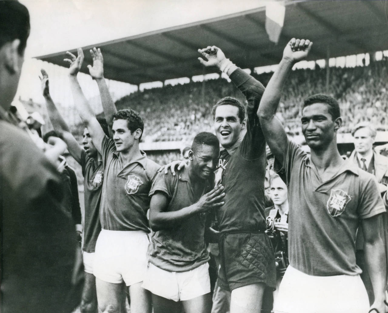 FILE - Brazil's 17-year-old Pele weeps on the shoulder of goalkeeper Gylmar Dos Santos Neves after ...