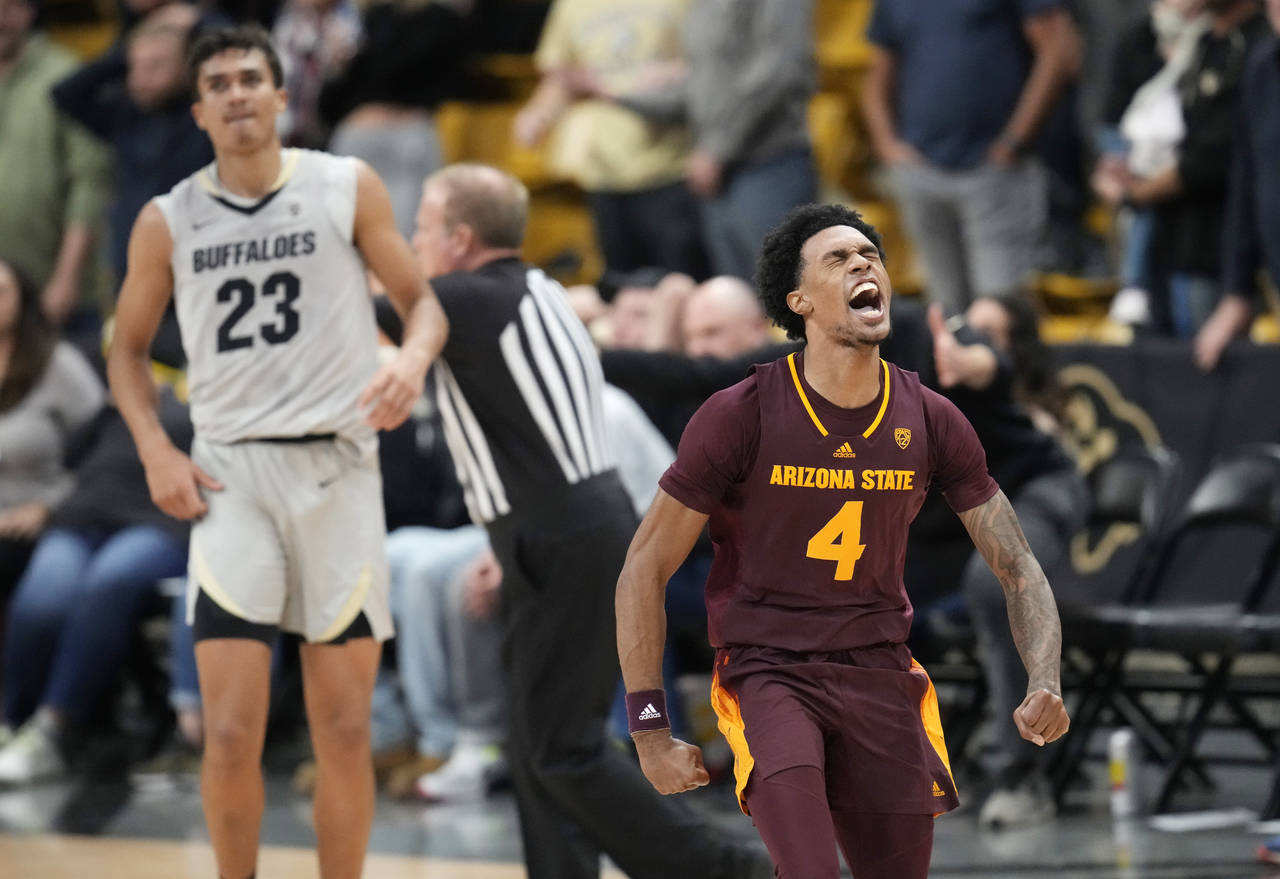 Arizona State guard Desmond Cambridge Jr. (4) reacts after hitting the winning 3-point basket as Co...