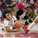 No. 9 Arkansas takes control late, tops UNC Greensboro 65-58