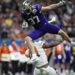 
              Washington tight end Jack Westover (37) is upended by Texas linebacker Jaylan Ford (41) after making a catch during the second half of the Alamo Bowl NCAA college football game in San Antonio, Thursday, Dec. 29, 2022. (AP Photo/Eric Gay)
            