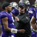
              Washington head coach Kalen DeBoer, center, talks with quarterback Michael Penix Jr. (9) during the first half of the Alamo Bowl NCAA college football game against Texas in San Antonio, Thursday, Dec. 29, 2022. (AP Photo/Eric Gay)
            
