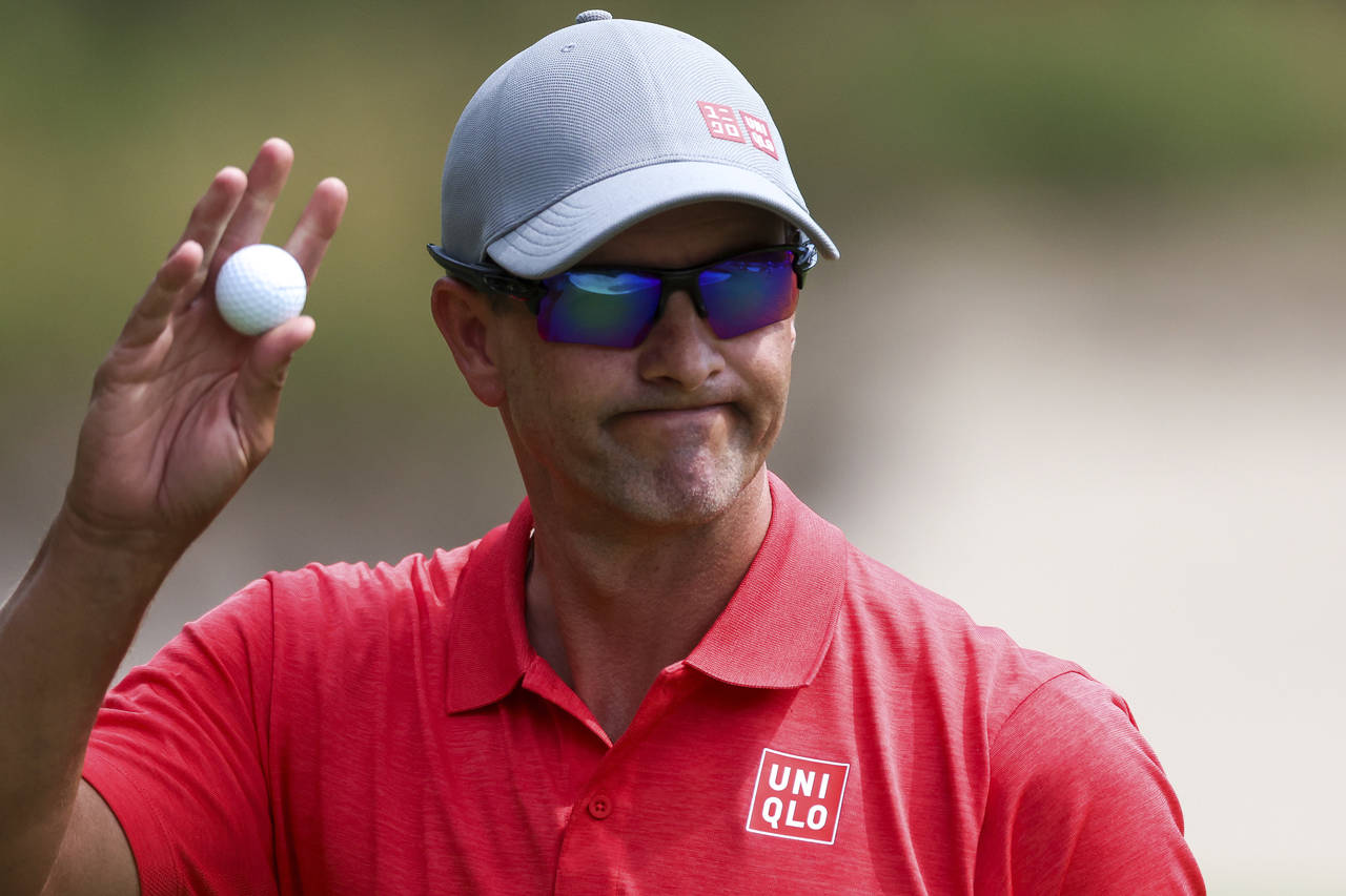 Australia's Adam Scott acknowledges the crowd on the 13th hole during the Australian Open golf cham...