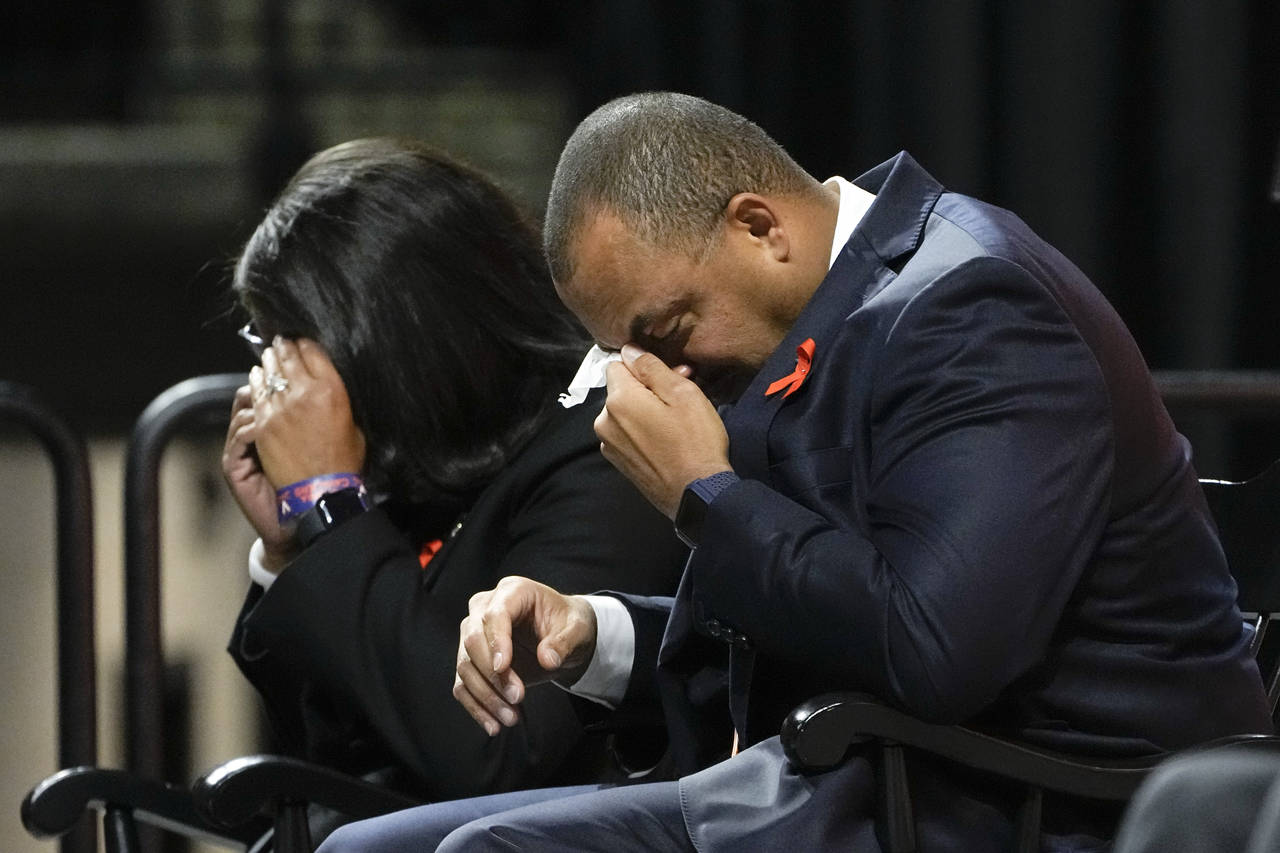University of Virginia Athletic Director Carla Williams, left, and football coach Tony Elliott wipe...