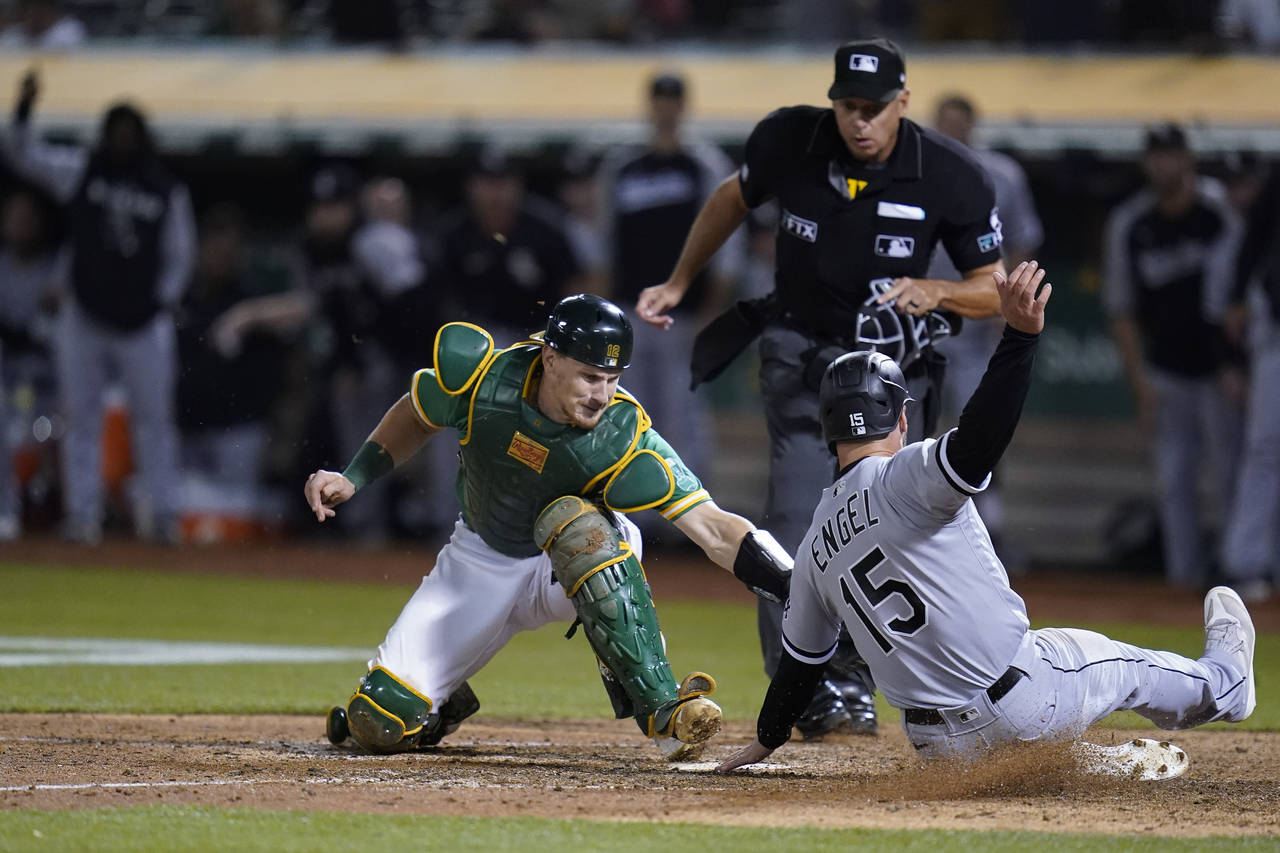 FILE - Oakland Athletics catcher Sean Murphy, left, tries to tag Chicago White Sox's Adam Engel (15...