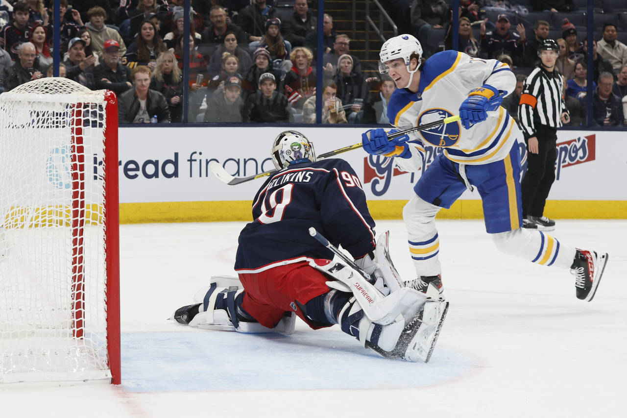 Buffalo Sabres' Tage Thompson, right, scores a goal against Columbus Blue Jackets' Elvis Merzlikins...