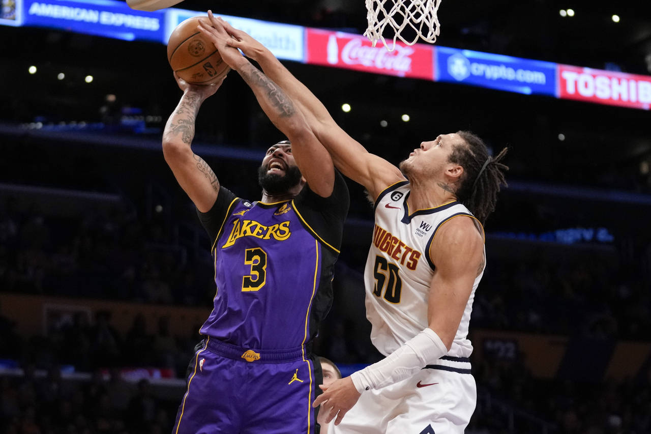 Los Angeles Lakers forward Anthony Davis (3) shoots against Denver Nuggets forward Aaron Gordon (50...