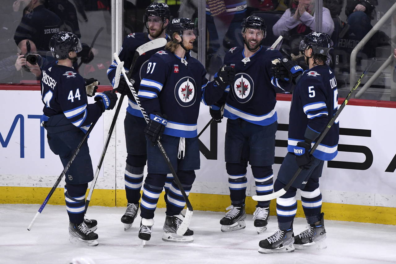 Winnipeg Jets' Sam Gagner (89) celebrates his goal against the Ottawa Senators with Josh Morrissey ...
