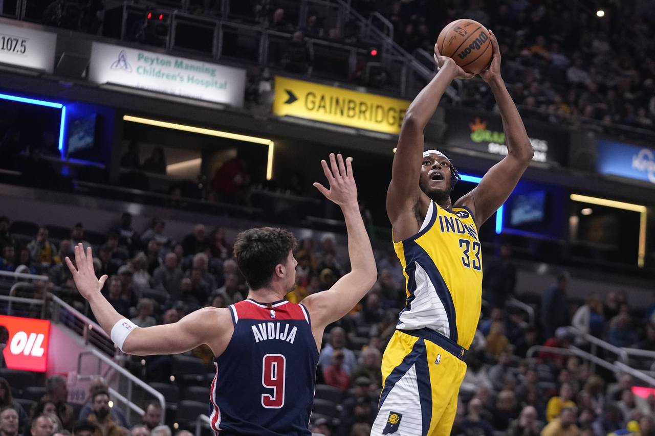 Indiana Pacers center Myles Turner (33) shoots over Washington Wizards forward Deni Avdija (9) duri...
