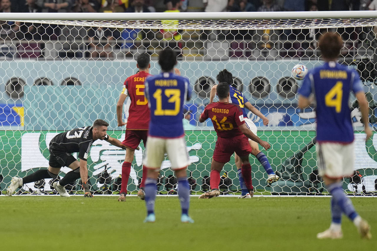 Japan's Ao Tanaka (17) scores their second goal during the World Cup group E soccer match between J...