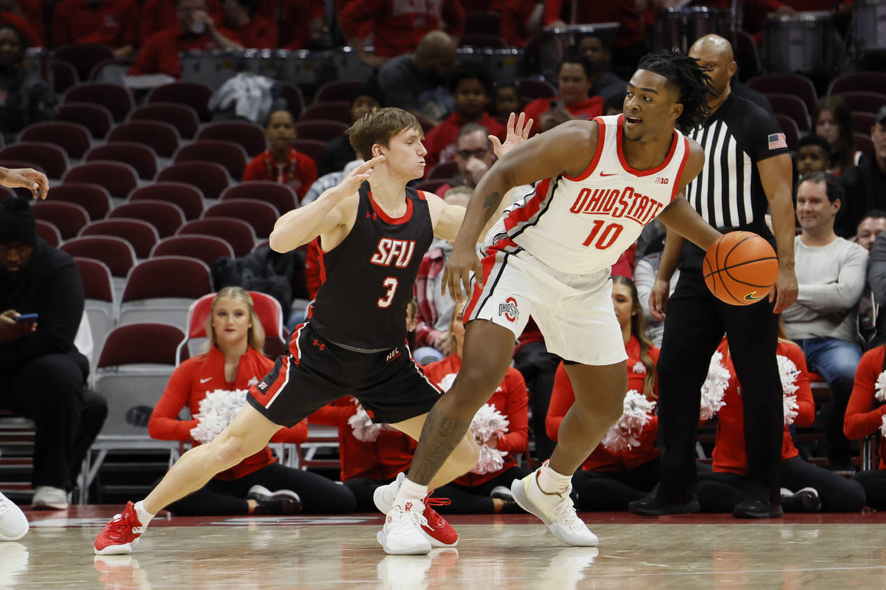 Ohio State's Brice Sensabaugh, right, posts up against Saint Francis' Luke Ruggery during the first...
