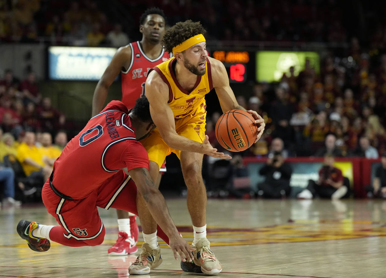 St. John's guard Posh Alexander (0) and Iowa State guard Gabe Kalscheur (22) collide during the fir...
