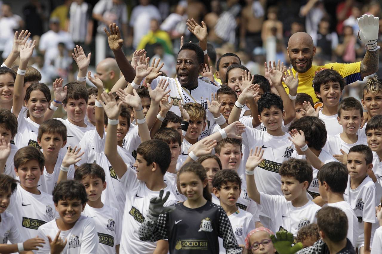 FILE - Brazilian soccer legend Pele, center top, and his son Edson Cholbi do Nascimento, above at r...