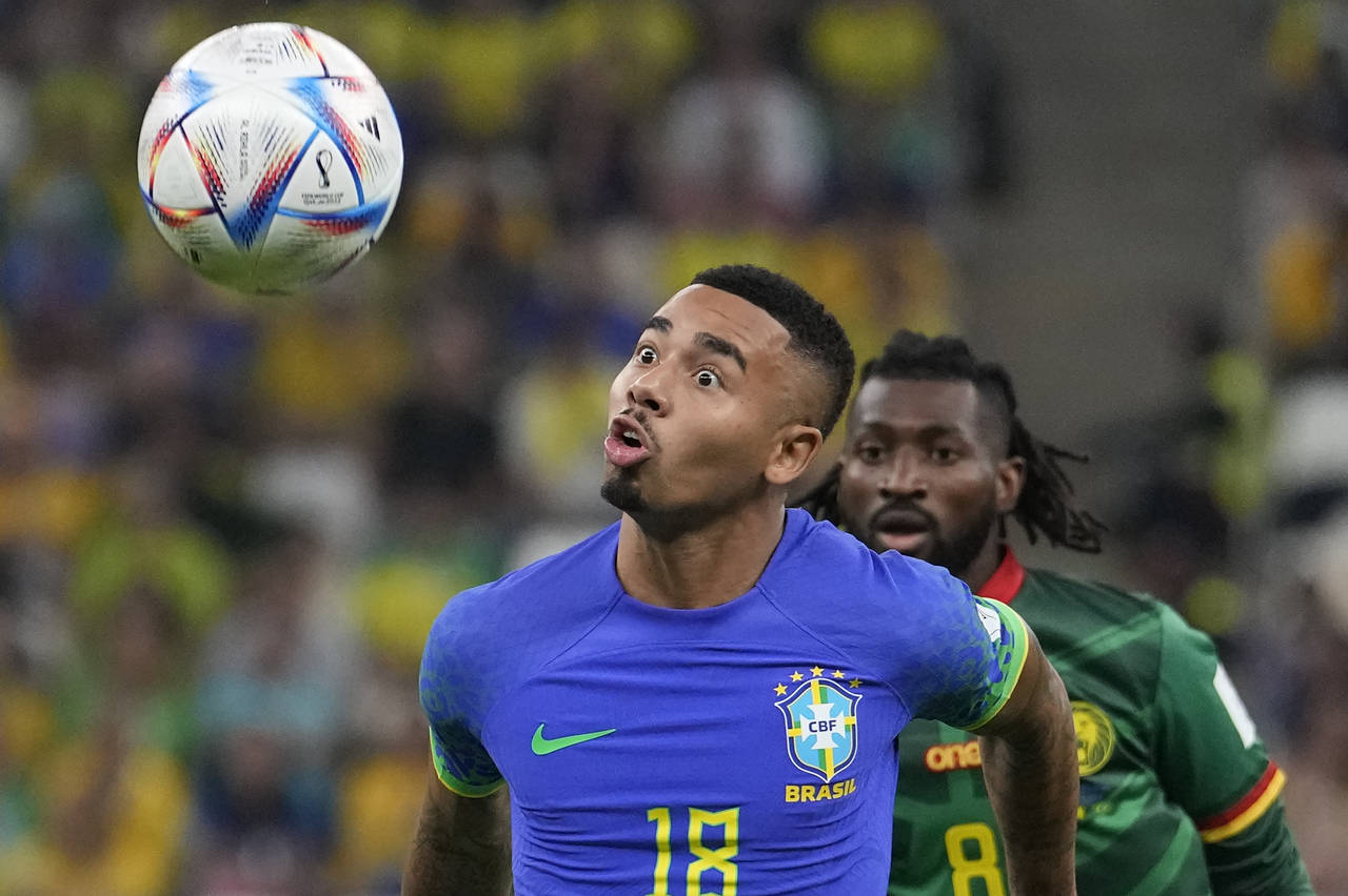 Brazil's Gabriel Jesus, front, and Cameroon's Andre-Frank Zambo Anguissa fight for he ball during t...