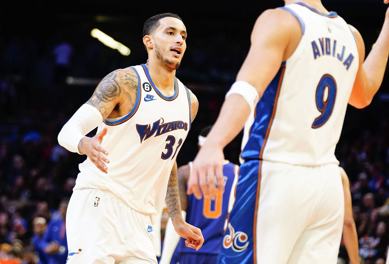 Washington Wizards' Kyle Kuzma gives a high five to Dani Avdija (9) after Kuzma put the Wizards up ...