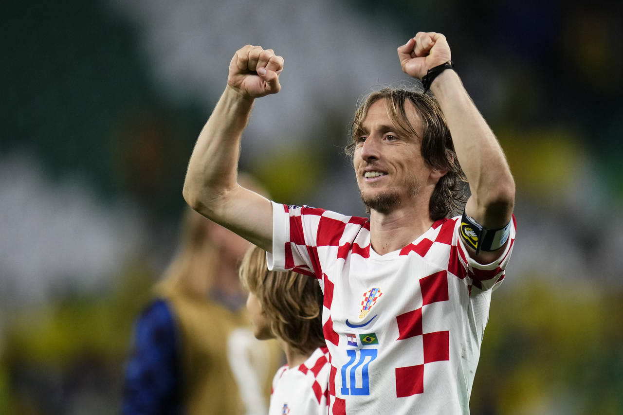 Luka Modric celebrates after Croatia defeated Brazil in a penalty shootout during a World Cup quart...